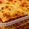 Lasaña casera en tupper lista para llevar — Delantales y Fogones Madrid